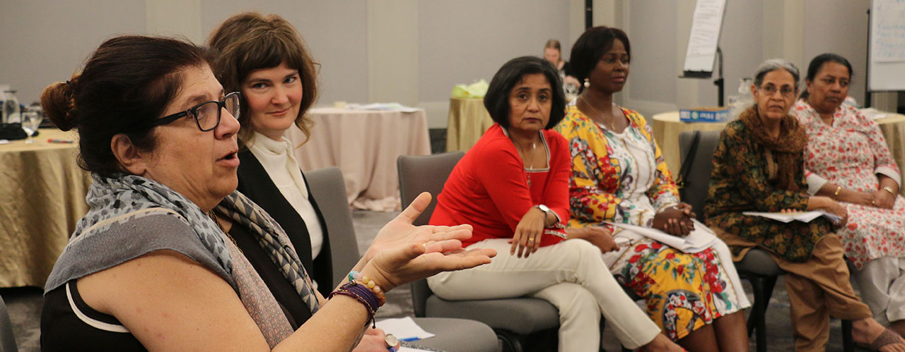 Members of Women Mediators across the Commonwealth talking together during a meeting